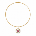 A delicate gold chain necklace with a small circular pendant featuring a pink rose on a white background, set against a plain white backdrop.