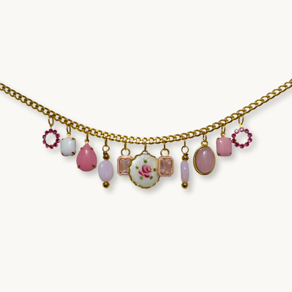 Layla Necklace featuring an Amour medium chain with 11 vintage-inspired charms in soft pink hues.