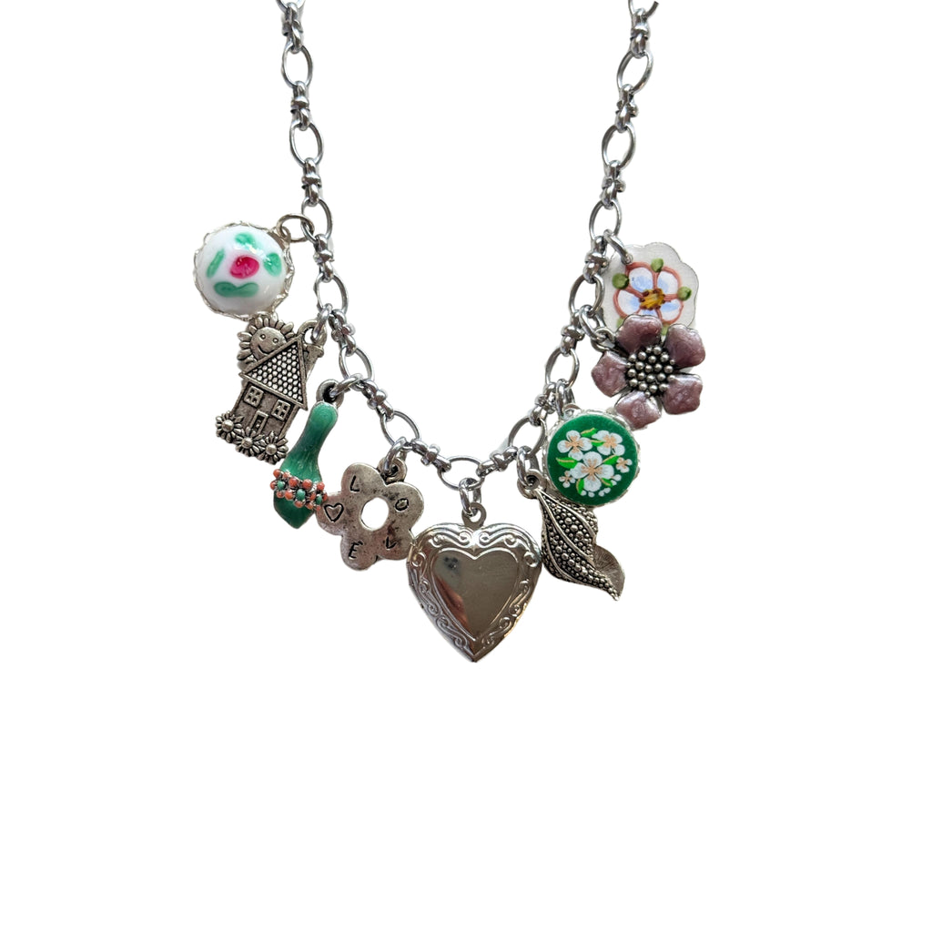 Close-up of hand-painted sandal and pink floral ceramic charm