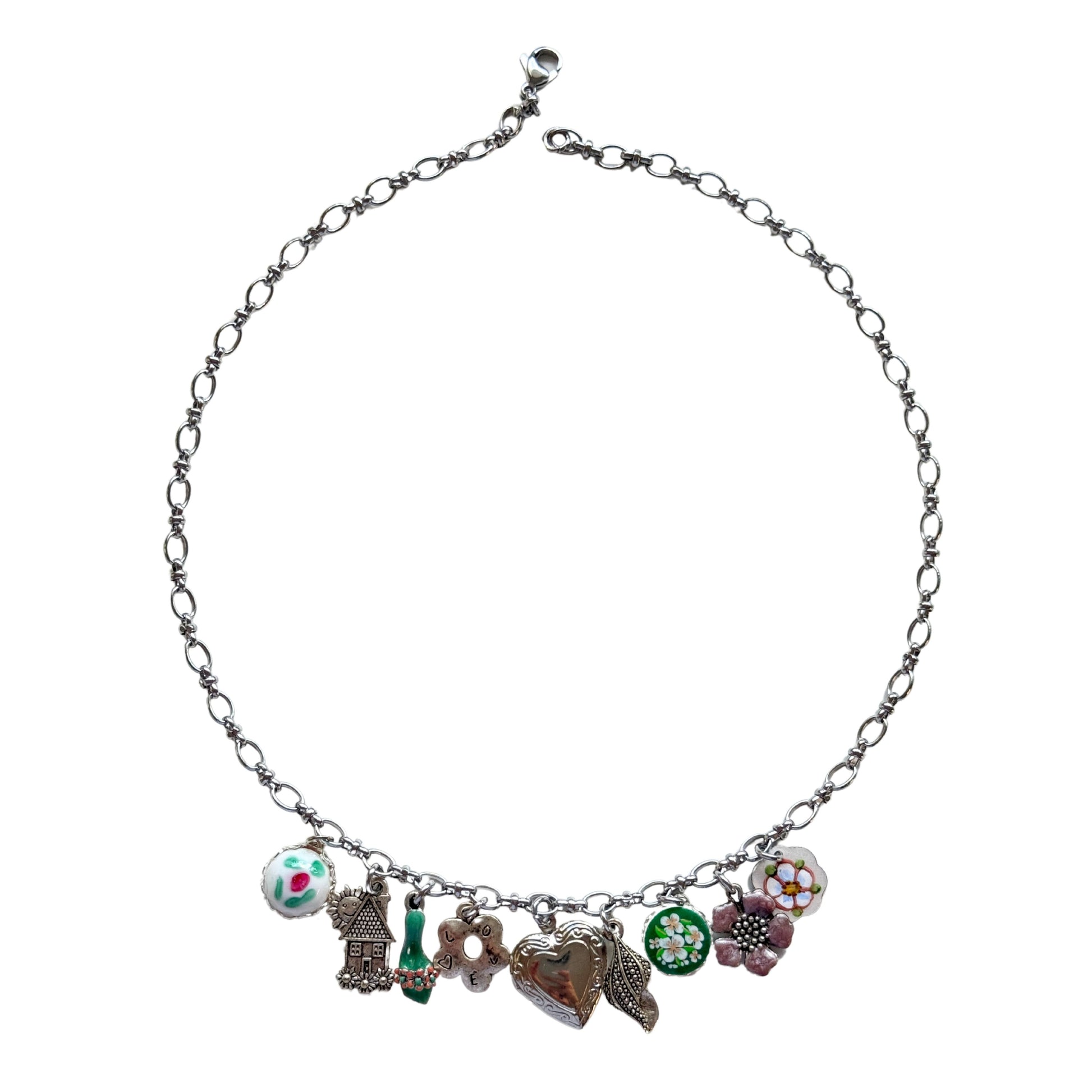 Lucette Necklace flatlay with floral charms and heart locket
