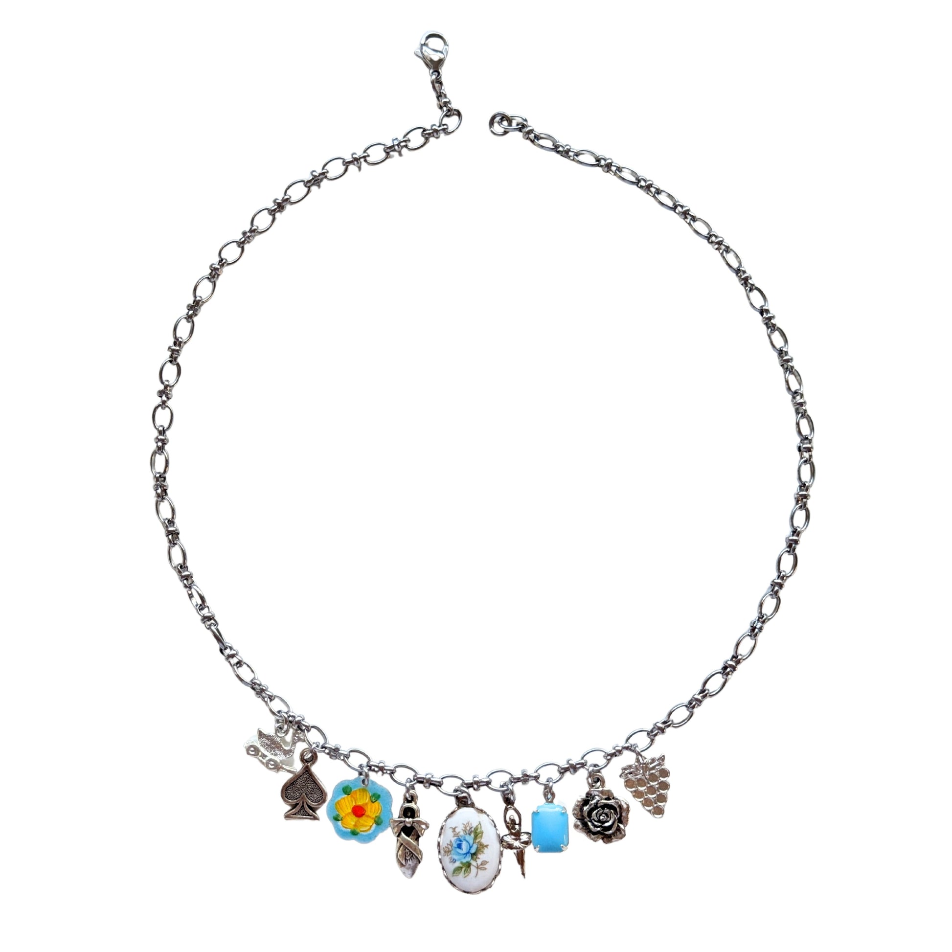 Lucia Necklace flatlay with duck pull toy and vintage charms