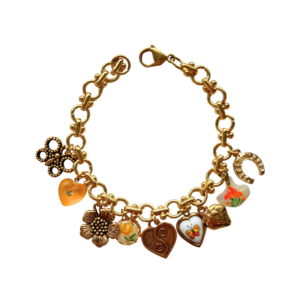 Gold-plated charm bracelet with strawberry, butterfly, and sunflower on a Yennifer chain