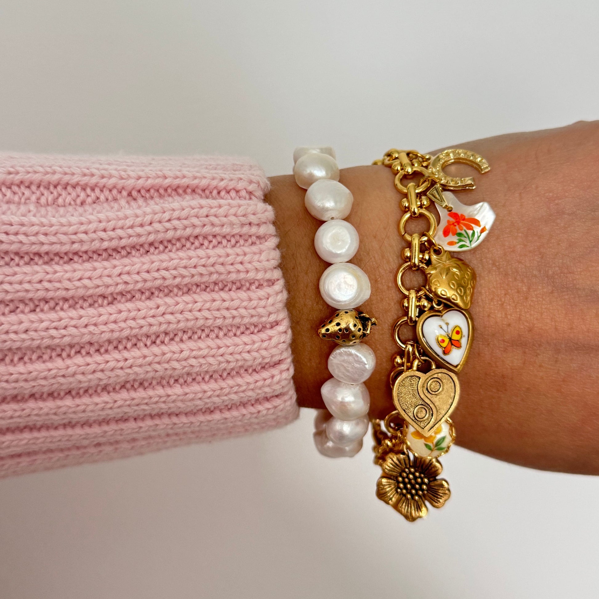 Close-up of Mandy Bracelet showing heart, horseshoe, and mother-of-pearl charm details