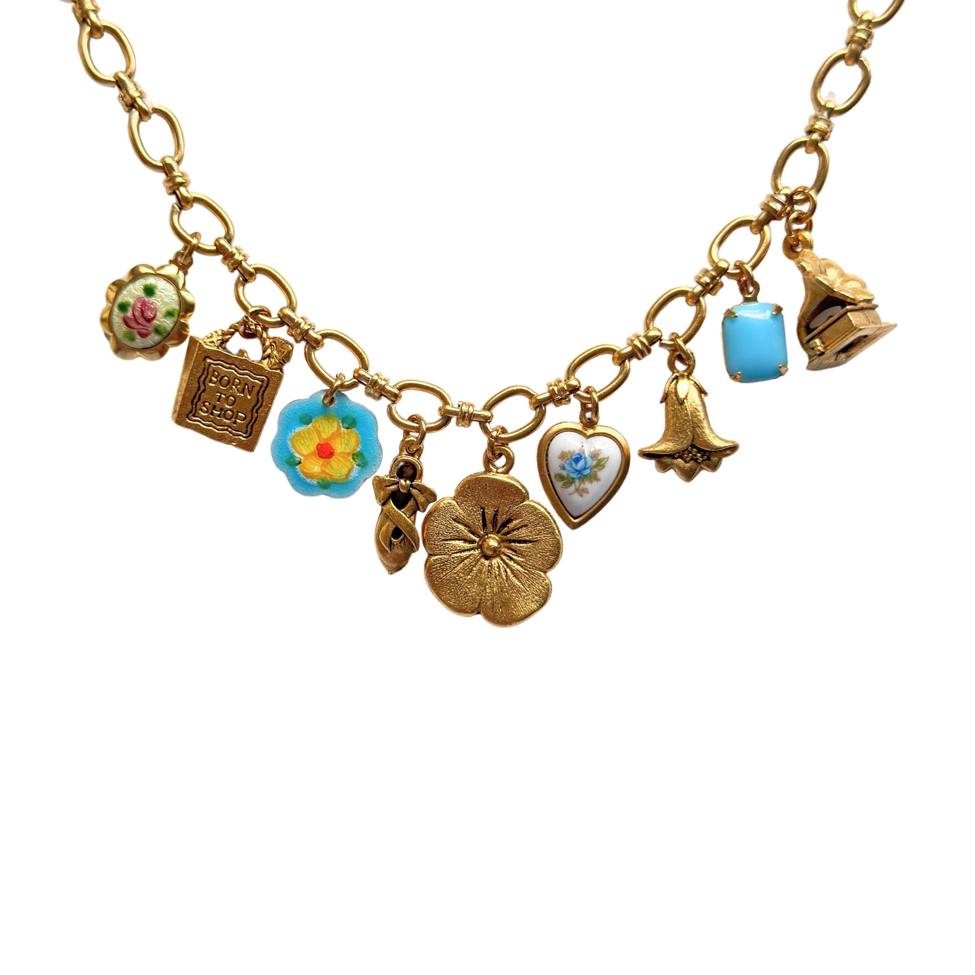 Close-up of shopping bag, ballerina slipper, and gramophone charms