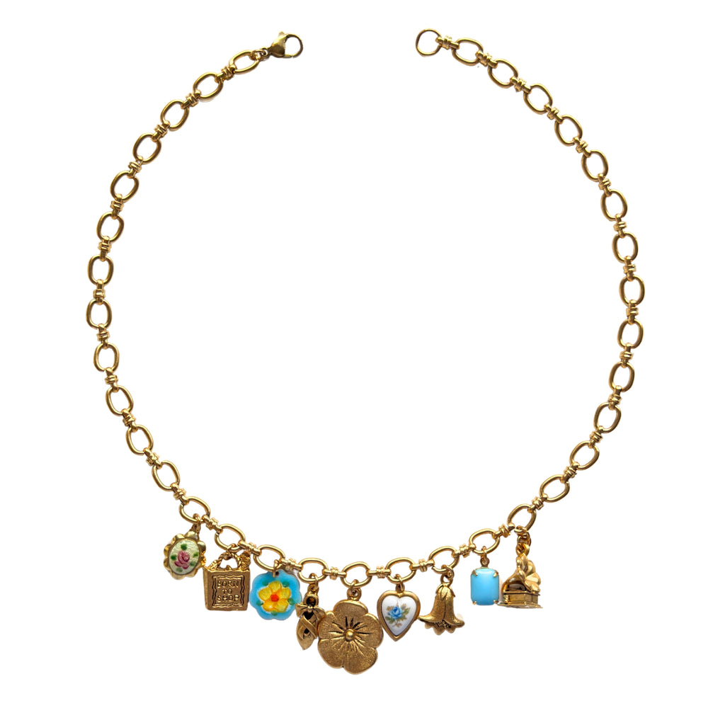 Manon Necklace flatlay with vintage-inspired charms