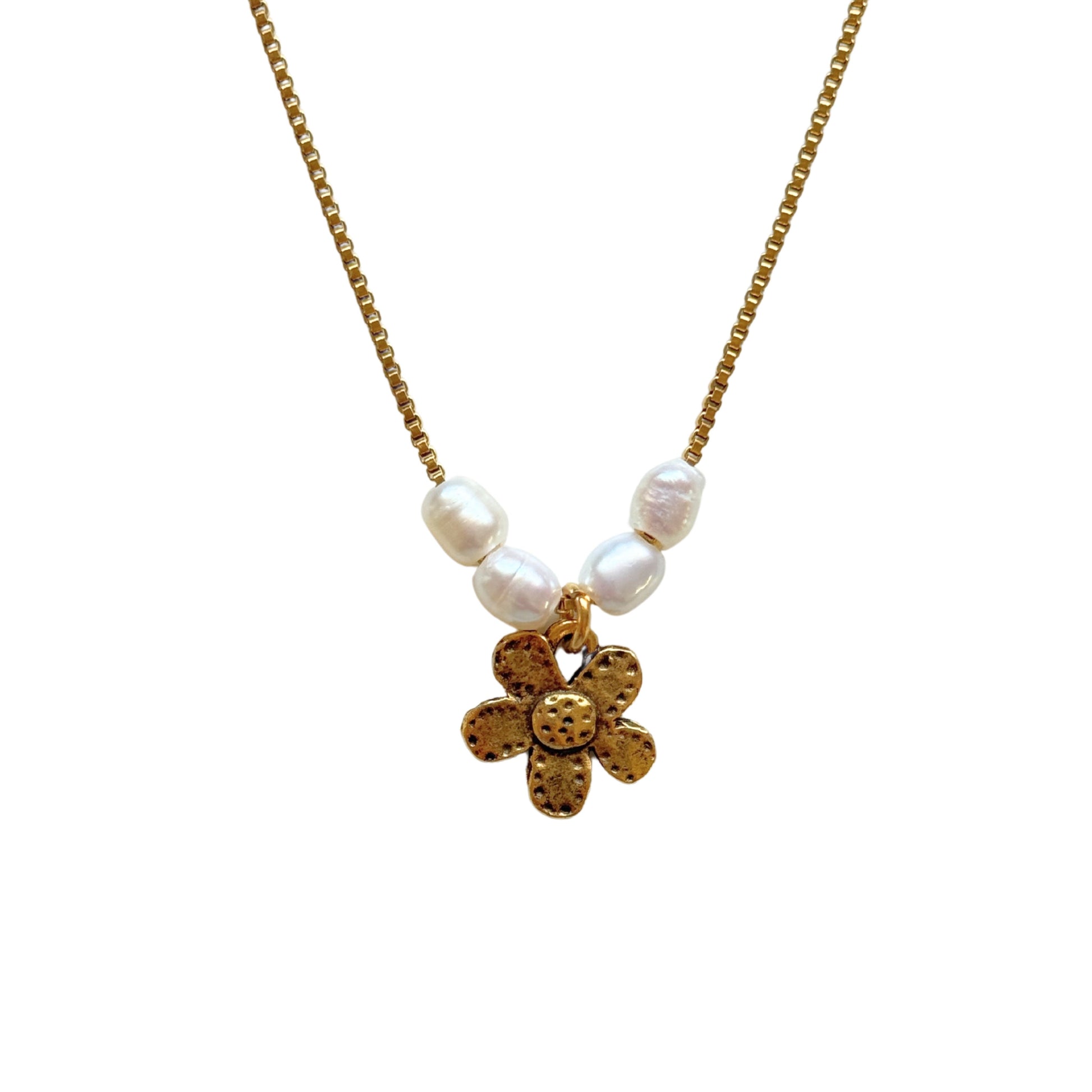 Close-up of freshwater pearls and dainty flower pendant