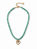 A beaded necklace featuring small, faceted green beads and a gold heart-shaped pendant, displayed on a clean white background.