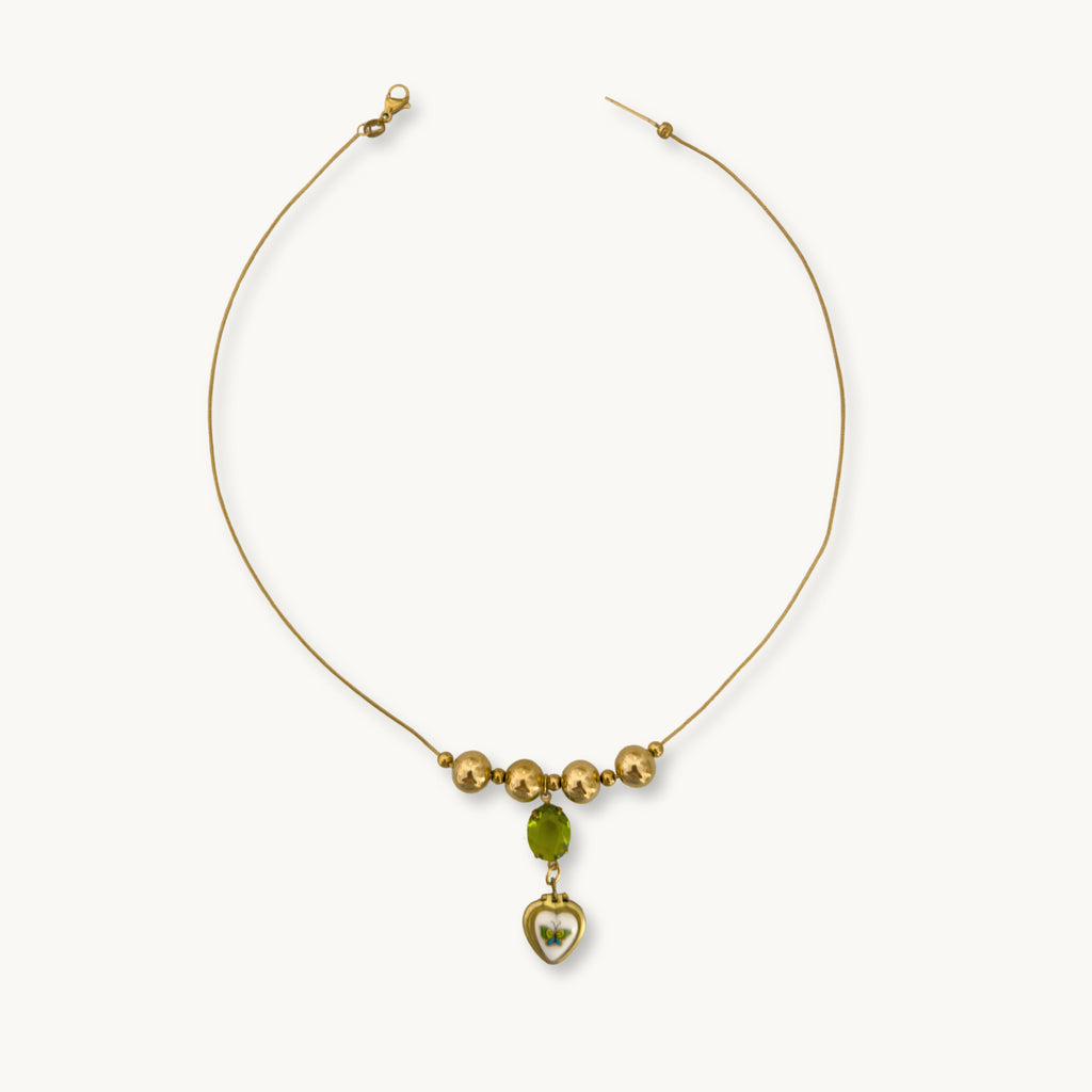 Flat-lay of the Miel Necklace against a neutral background for a classic look.