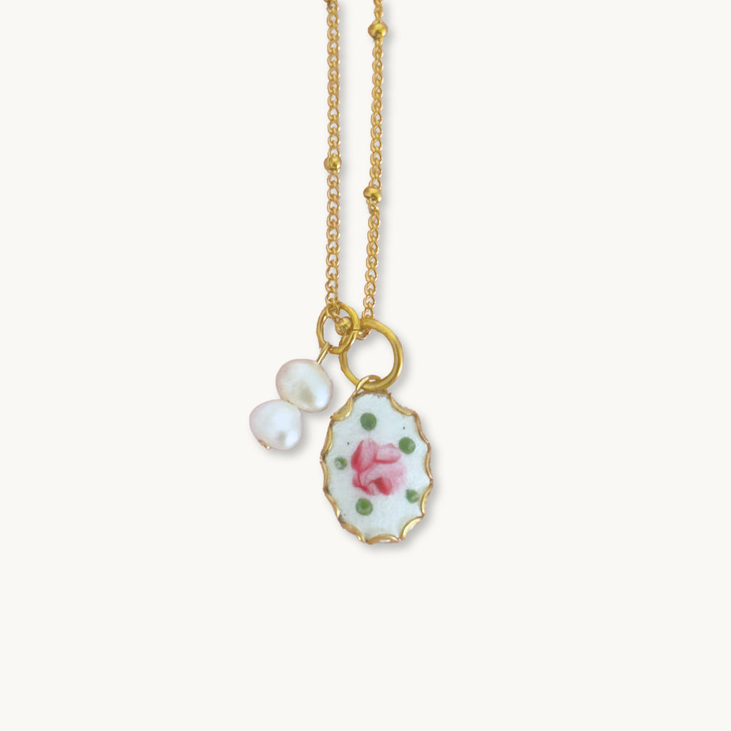 Close-up of the Muriel Necklace highlighting its delicate guilloche pendant and baroque pearl drops.