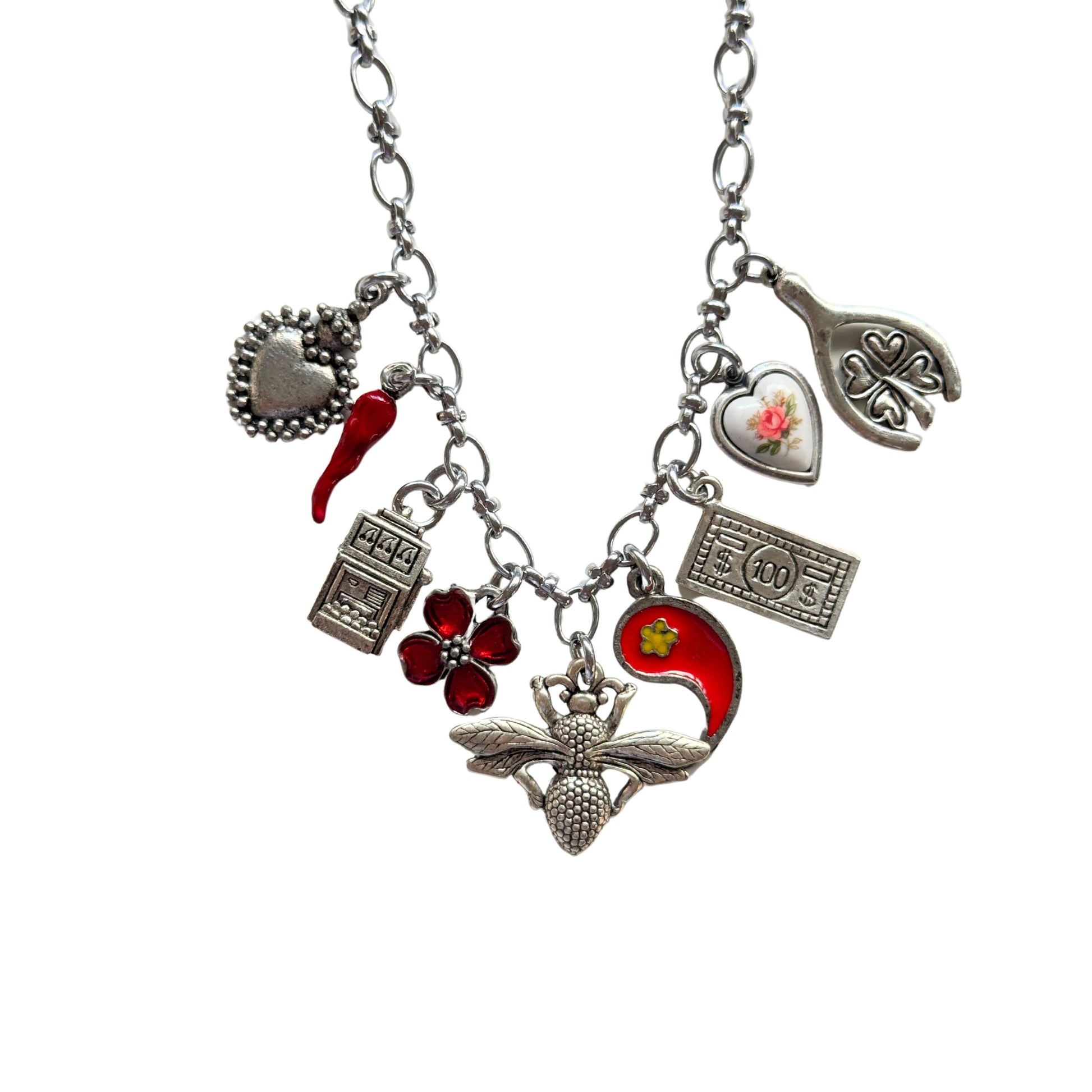 Close-up of antique pewter and vintage ceramic rose pendant