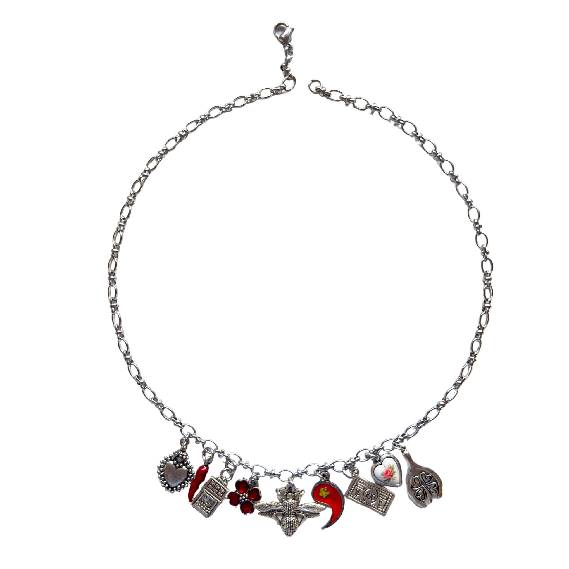 Ninette Necklace flatlay showing mermaid and fleur de lis charms