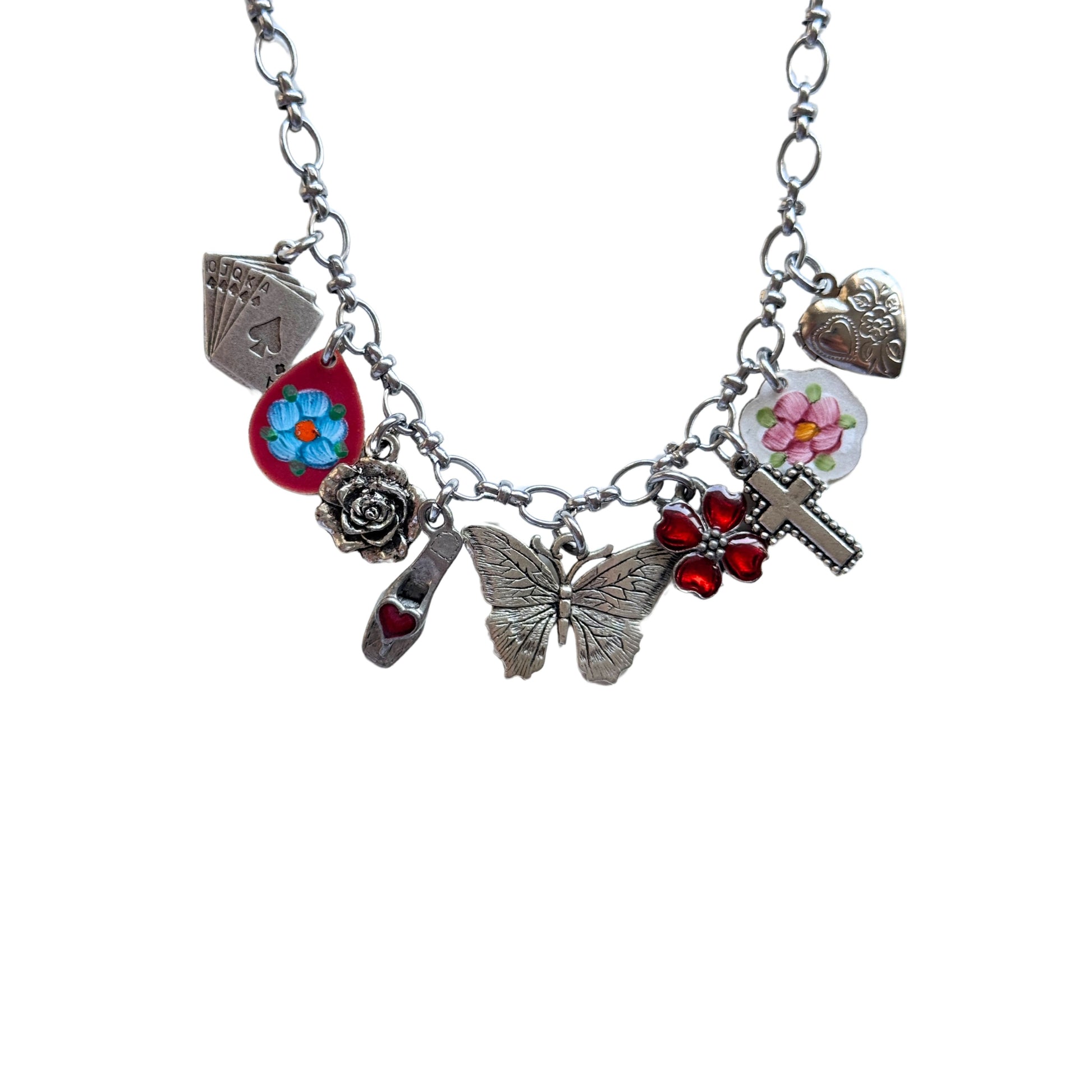 Close-up of hand-painted red flower and heart locket