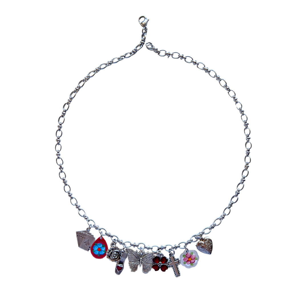 Odette Necklace flatlay showing all vintage-inspired charms