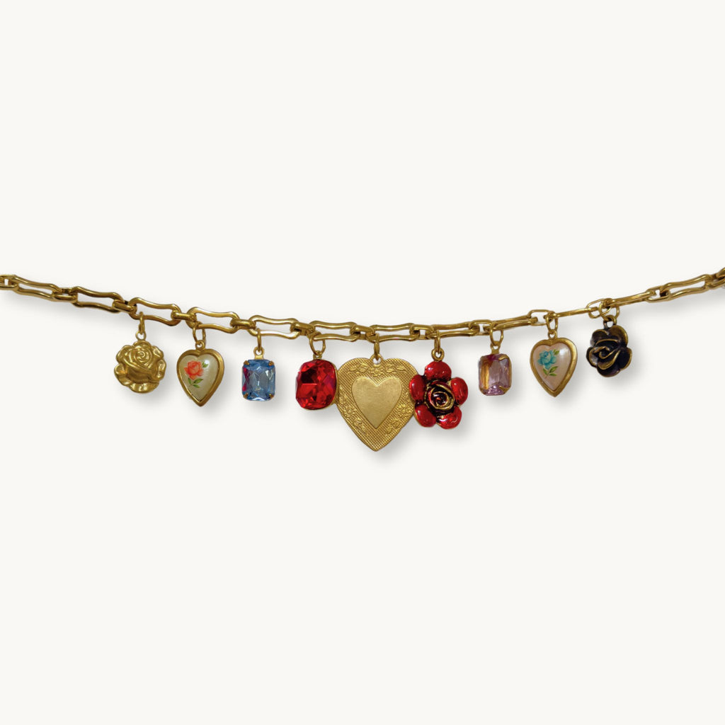 Close-up of the Olivia Necklace highlighting its enamel flower charms and intricate heart details.