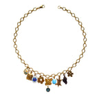 Paloma Necklace flatlay with butterfly and birdcage charms