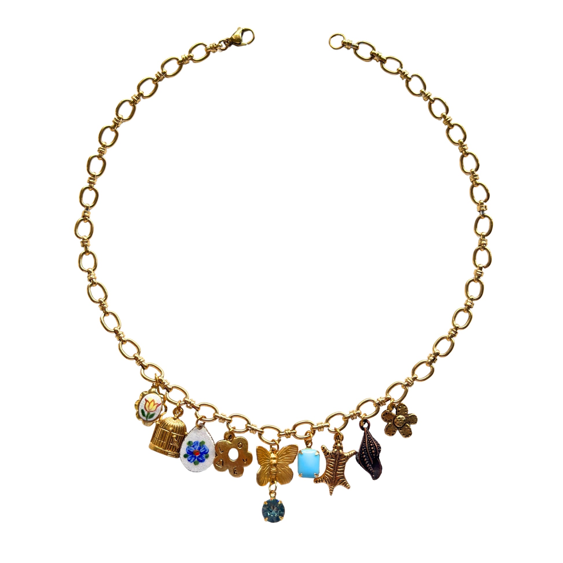 Paloma Necklace flatlay with butterfly and birdcage charms
