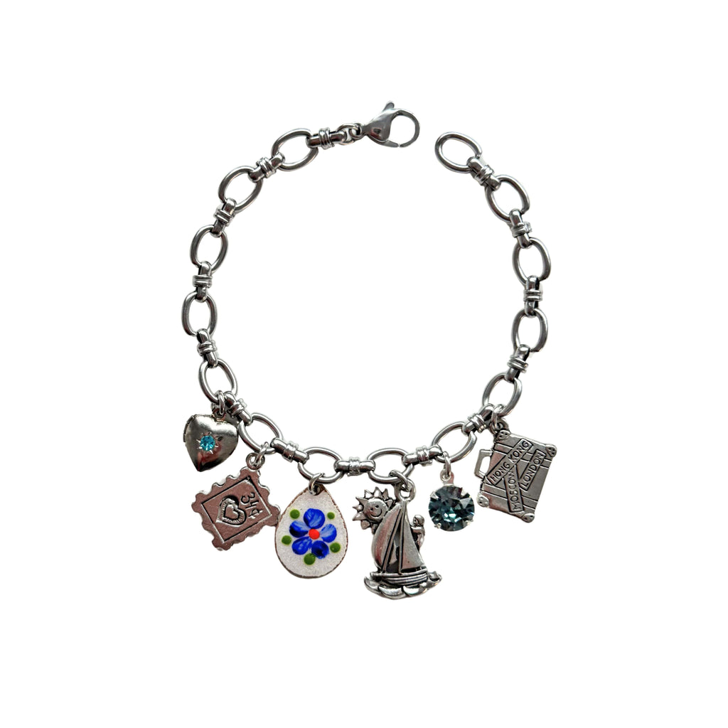 Close-up of vintage hand-painted blue flower guilloché charm