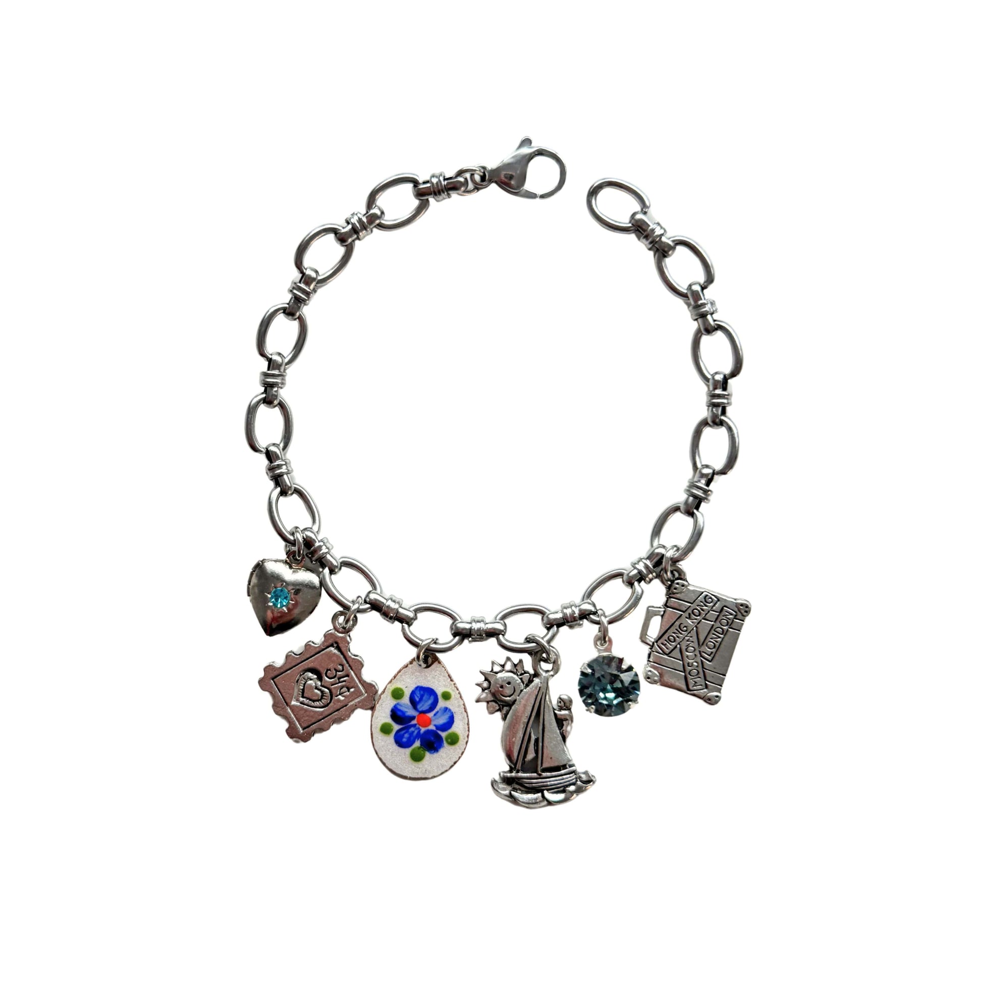 Close-up of vintage hand-painted blue flower guilloché charm