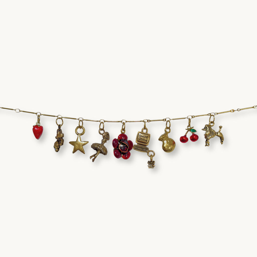 Flat lay of the Rosie Necklace, displaying its handpicked charms and intricate details.