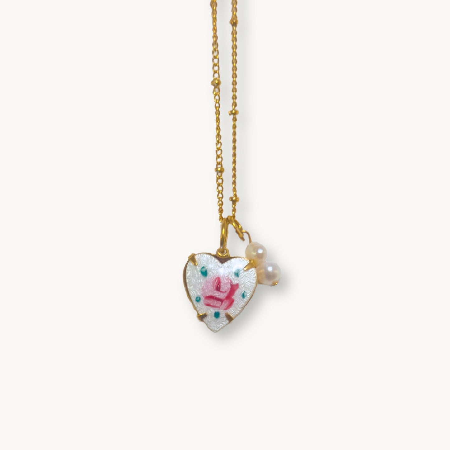 Close-up of the Rosina Necklace highlighting its intricate hand-painted rose and baroque pearl drops.