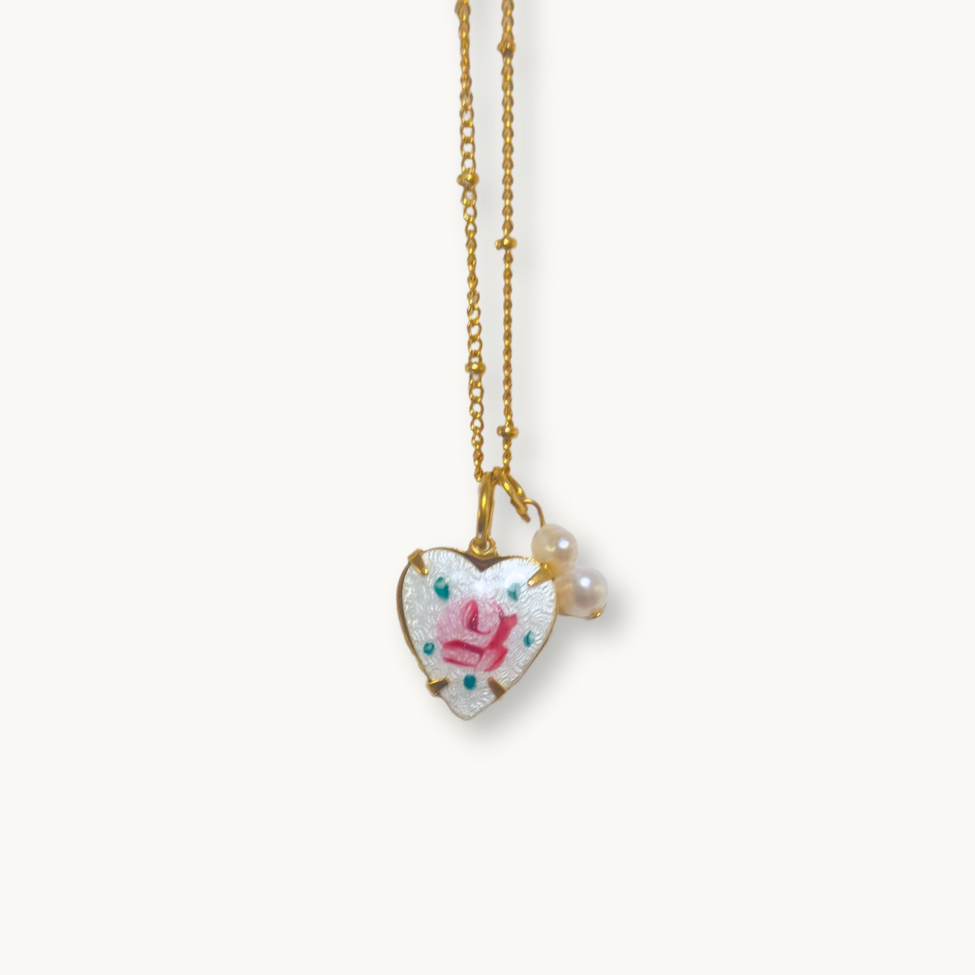 Close-up of the Rosina Necklace highlighting its intricate hand-painted rose and baroque pearl drops.
