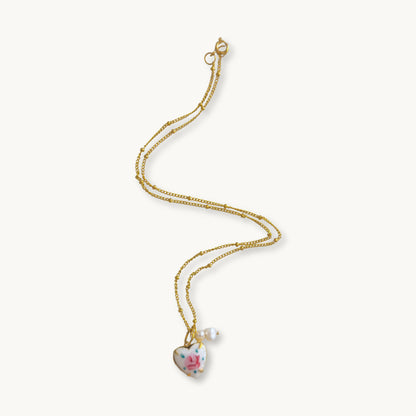 Rosina Necklace featuring a gold-plated beaded Figaro chain with a heart-shaped guilloche rose pendant.