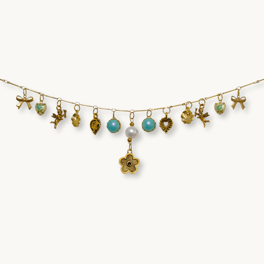 Close-up of the Sabrina Necklace showcasing its detailed mirrored charms and floral pearl drop.