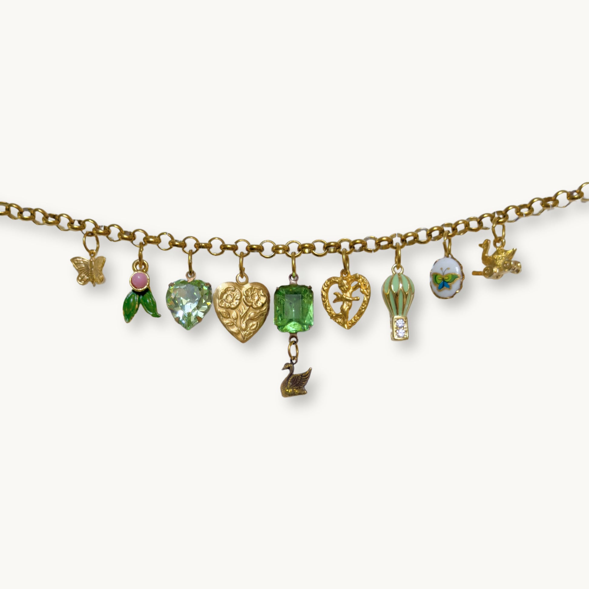 Close-up of the Shoban Necklace featuring a swan charm and green octagon stone.