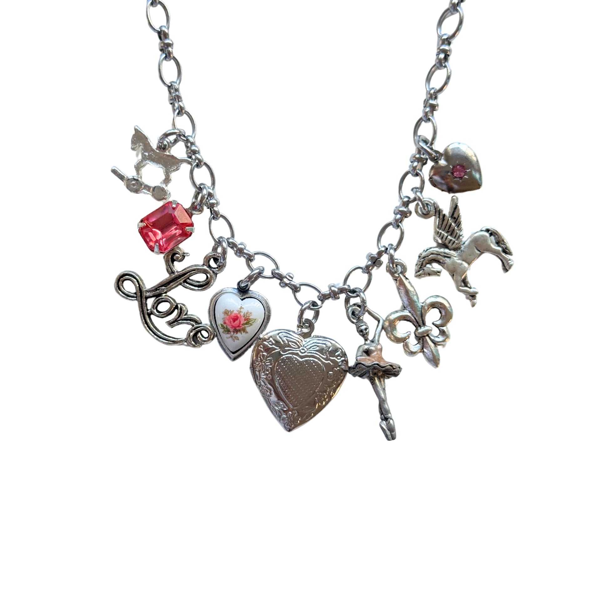 Close-up of silver pony and pink rose heart charm