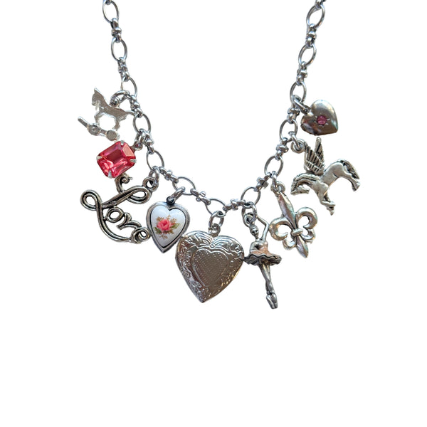 Close-up of silver pony and pink rose heart charm