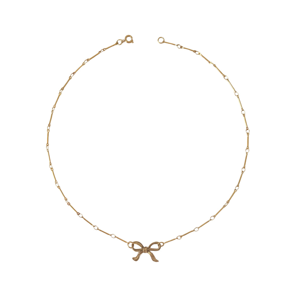 PVD gold-plated Tullah Necklace with bow detail, perfect for adding a feminine touch to casual or dressy outfits