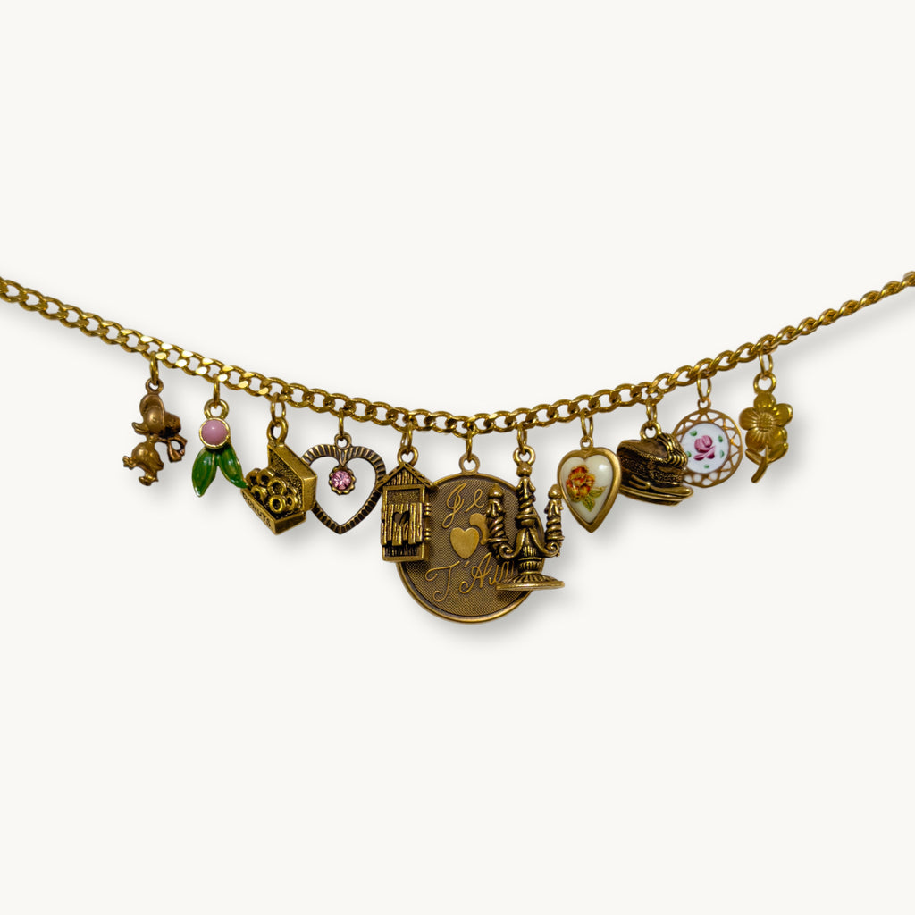 Close-up of the Willow Necklace with ‘Je T’aime’ pendant and whimsical vintage charms.