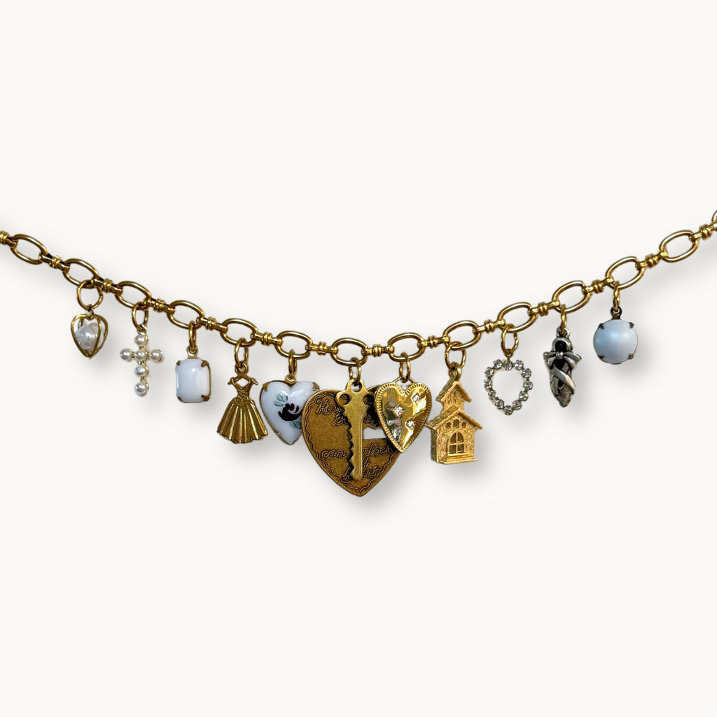Close-up of the Zara Necklace showcasing the pastel blue glass pearl cabochon and detachable key charm.